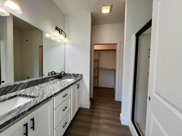 bathroom featuring vanity, toilet, hardwood / wood-style flooring, and a shower with door