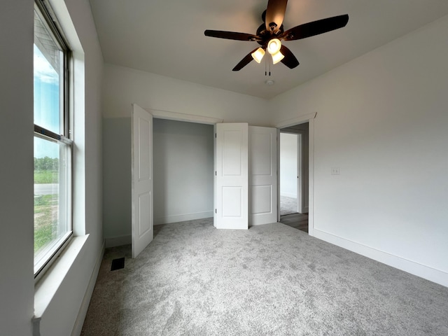 unfurnished bedroom with carpet flooring and ceiling fan