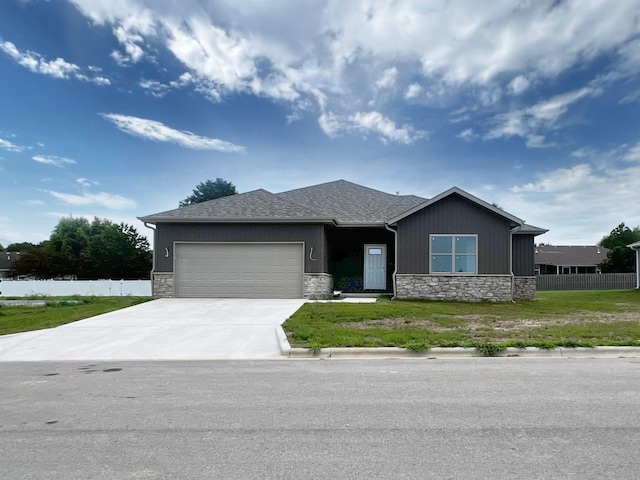 view of front of property with a front yard and a garage