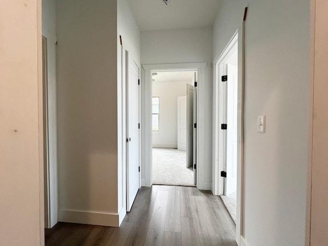 hallway with dark hardwood / wood-style floors