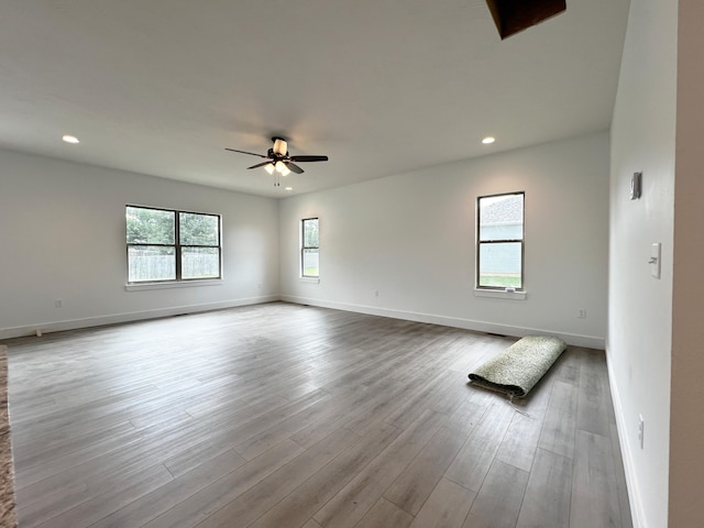 spare room with light hardwood / wood-style floors and ceiling fan