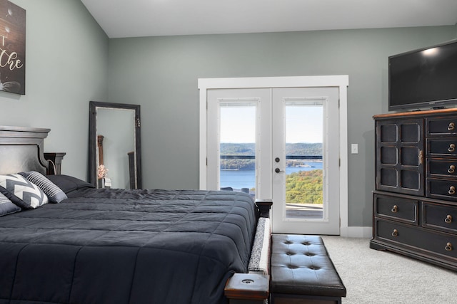 carpeted bedroom featuring access to exterior, french doors, and lofted ceiling