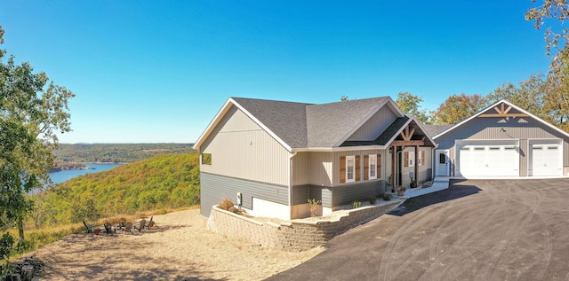 view of front of property featuring a garage and a water view