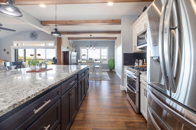 kitchen featuring dark hardwood / wood-style floors, decorative light fixtures, light stone counters, white cabinetry, and stainless steel appliances