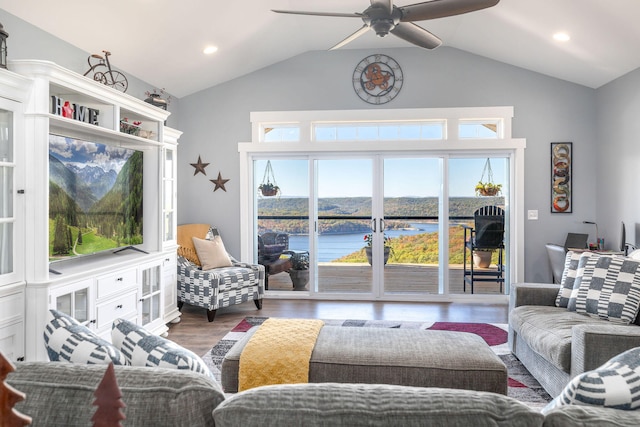 living room featuring a wealth of natural light, a water view, and vaulted ceiling