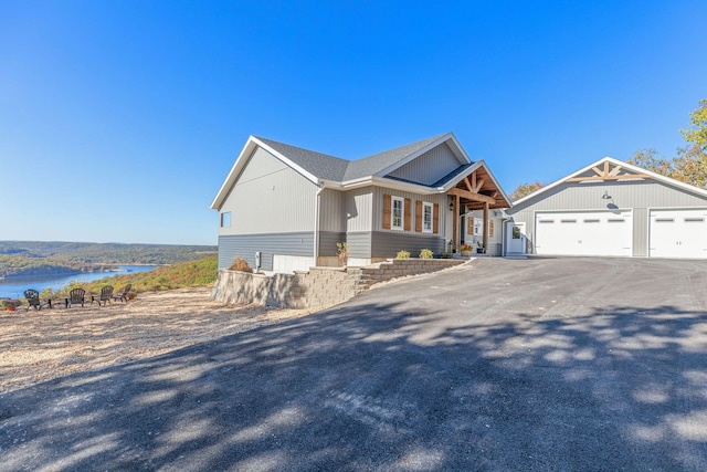 craftsman house featuring a water view and a garage