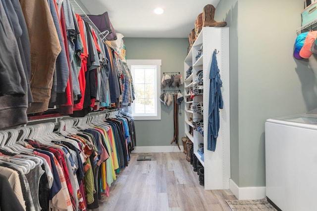 spacious closet featuring light wood-type flooring and washer / clothes dryer