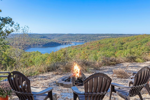 view of patio / terrace with a water view and an outdoor fire pit