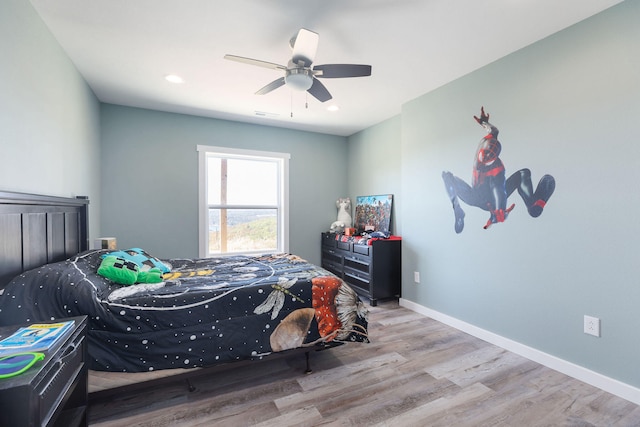 bedroom with light wood-type flooring and ceiling fan