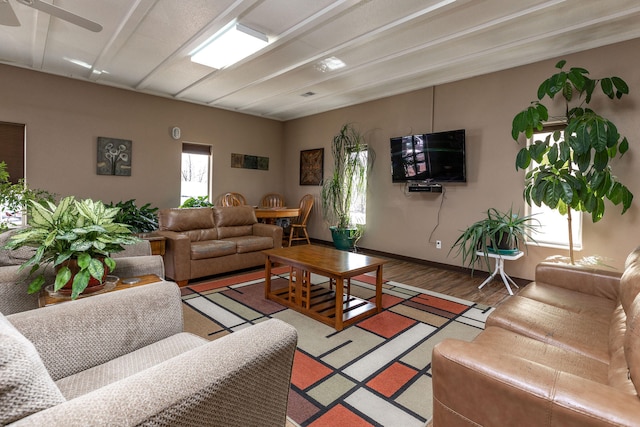 living room with hardwood / wood-style flooring and ceiling fan