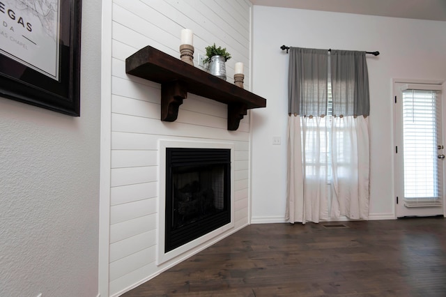 unfurnished living room with dark hardwood / wood-style floors