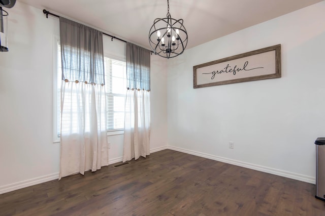 unfurnished dining area with a notable chandelier and dark hardwood / wood-style flooring