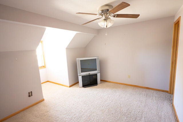 additional living space with ceiling fan, lofted ceiling, and light colored carpet