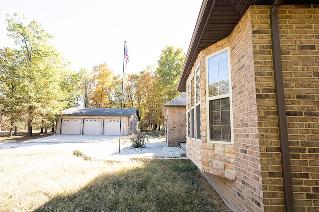 21620 County Road 232, Hermitage, MO 65668 - view of side of property with brick siding, an outbuilding, and a detached garage