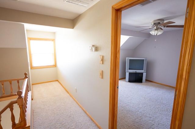 hallway with light carpet and lofted ceiling