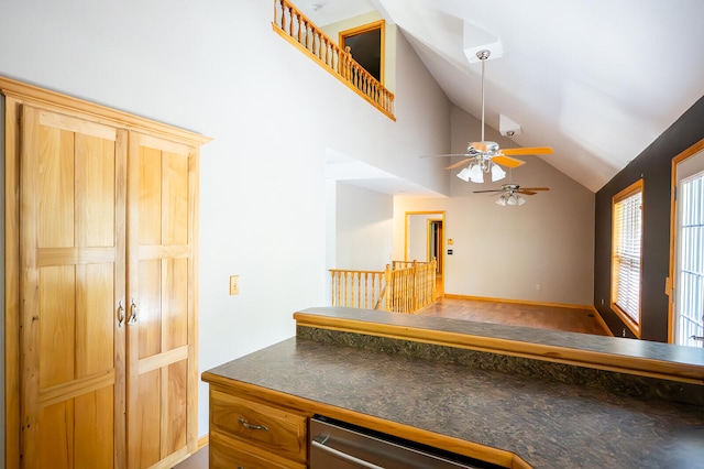 kitchen with ceiling fan, high vaulted ceiling, wood-type flooring, and dishwasher