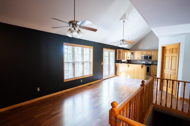 interior space with french doors, ceiling fan, vaulted ceiling, and hardwood / wood-style floors