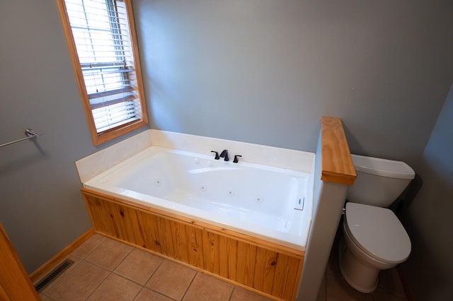 bathroom with tile patterned flooring, toilet, and a washtub