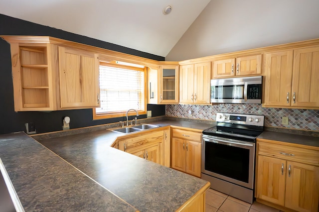 kitchen featuring backsplash, appliances with stainless steel finishes, light tile patterned floors, high vaulted ceiling, and sink