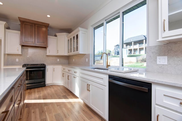 kitchen with sink, stainless steel dishwasher, black stove, and white cabinets