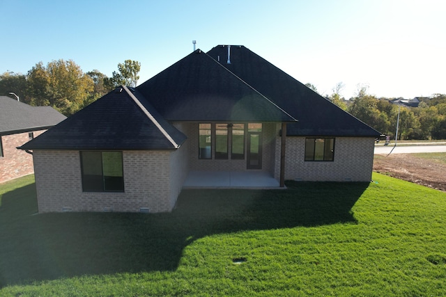 back of house with a patio area and a yard