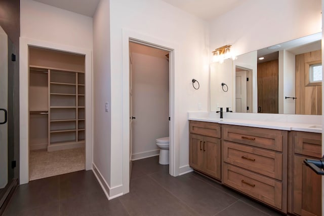 bathroom featuring vanity, toilet, and tile patterned flooring