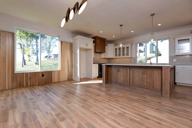 kitchen featuring white cabinetry, a wealth of natural light, light wood-type flooring, and a kitchen island