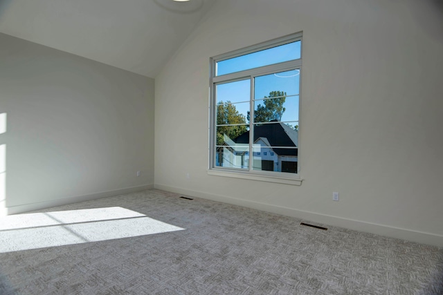 additional living space featuring vaulted ceiling and light carpet