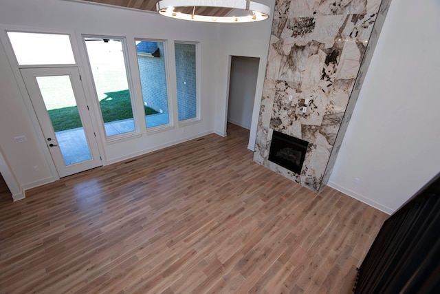 unfurnished living room featuring a premium fireplace and wood-type flooring