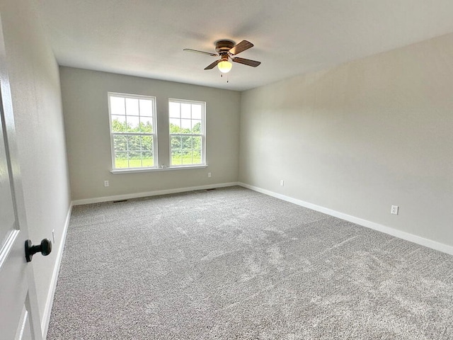 spare room featuring ceiling fan and carpet floors