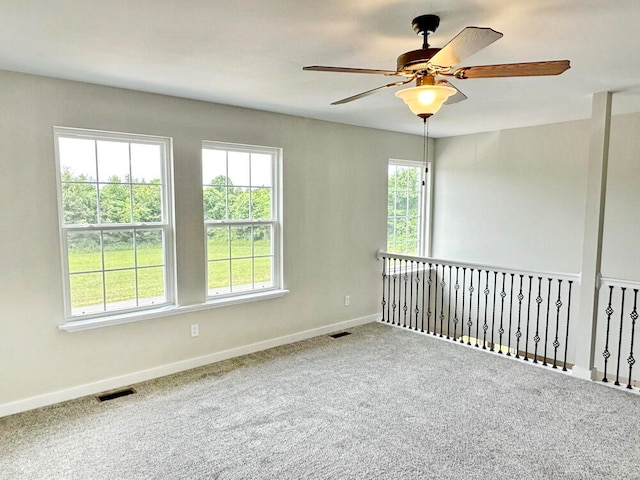 empty room with carpet floors and ceiling fan