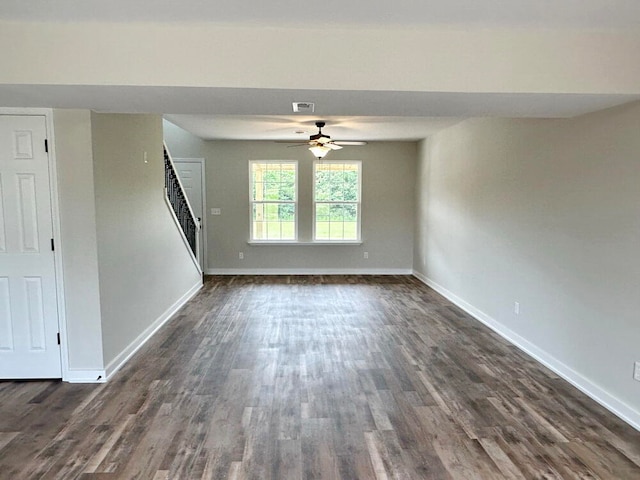 interior space with dark wood-type flooring and ceiling fan