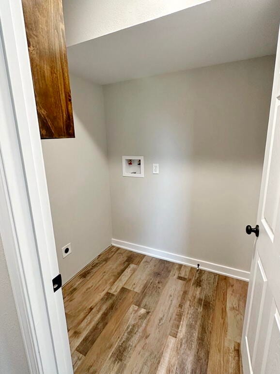 laundry room featuring hookup for a washing machine, light hardwood / wood-style flooring, and hookup for an electric dryer