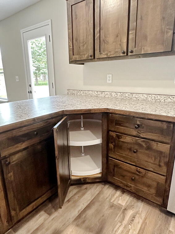 kitchen featuring dark brown cabinets and light wood-type flooring