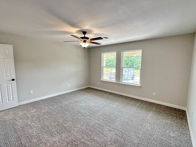 spare room featuring carpet, a textured ceiling, and ceiling fan