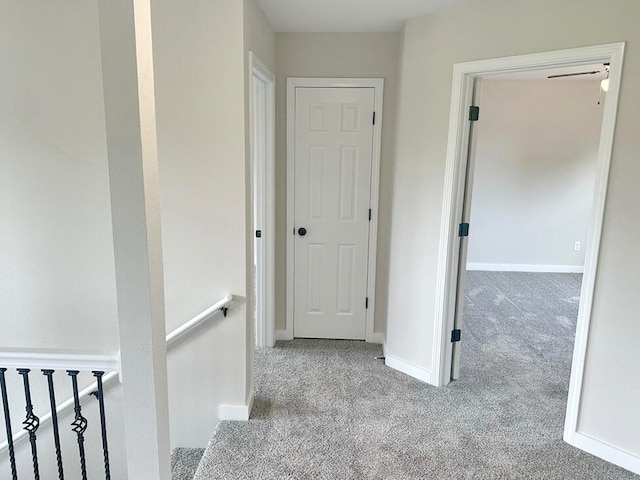 hallway featuring light colored carpet