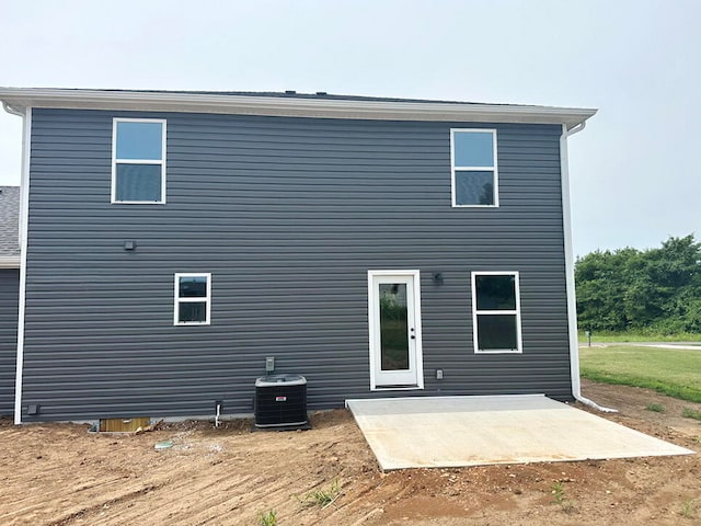 back of property with a patio and central AC