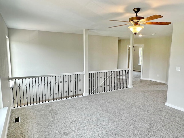 carpeted empty room featuring ceiling fan