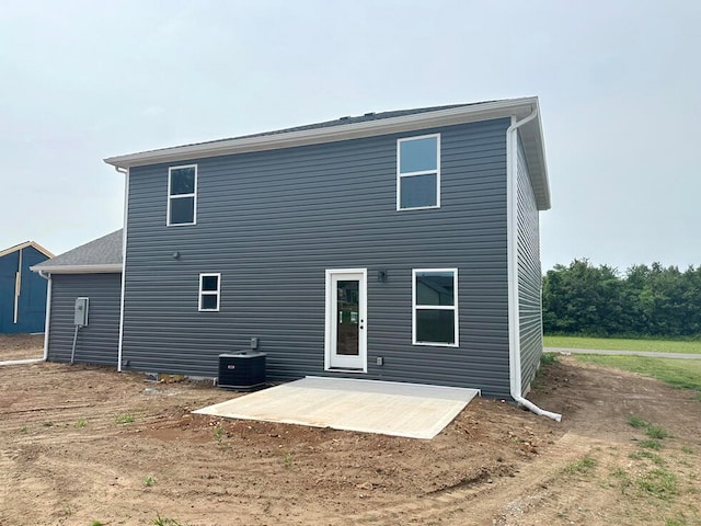 rear view of property with a patio area and central AC