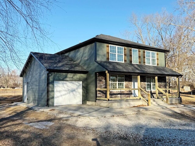 view of front of home with a porch and a garage