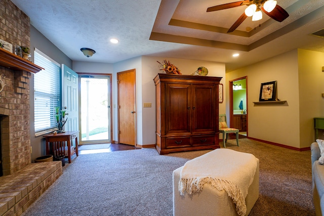 bedroom with access to outside, carpet, a brick fireplace, a textured ceiling, and ceiling fan