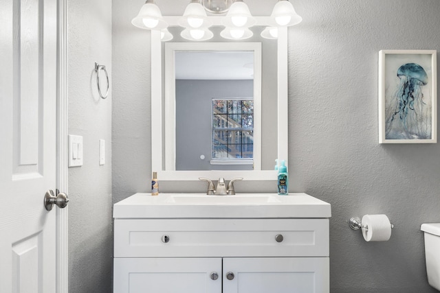 bathroom with toilet and vanity