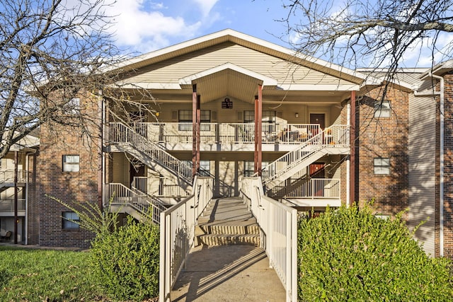 rear view of house featuring covered porch