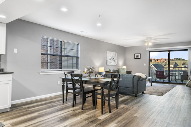 dining area with dark hardwood / wood-style floors and ceiling fan