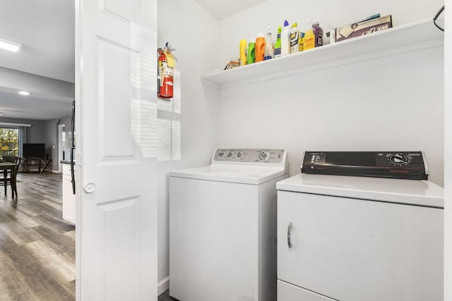 washroom featuring hardwood / wood-style flooring and separate washer and dryer