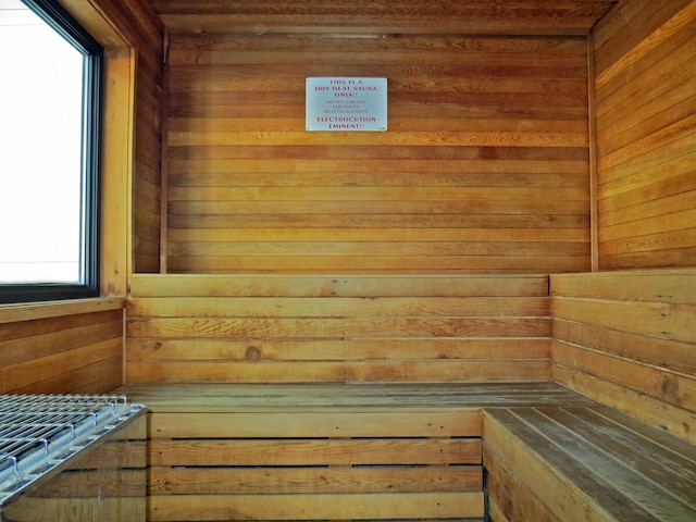 view of sauna featuring wood walls