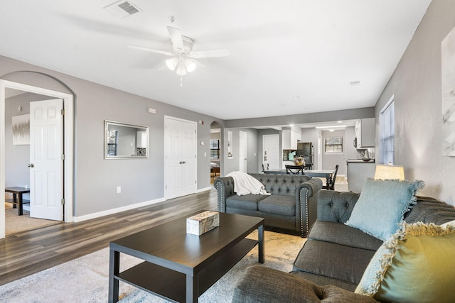 living room featuring hardwood / wood-style flooring and ceiling fan