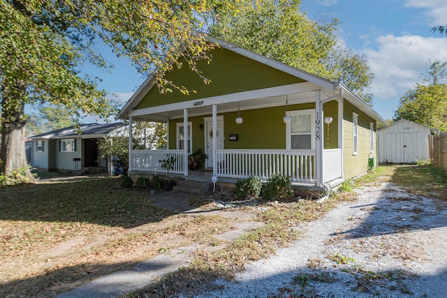 bungalow featuring a storage shed and a porch