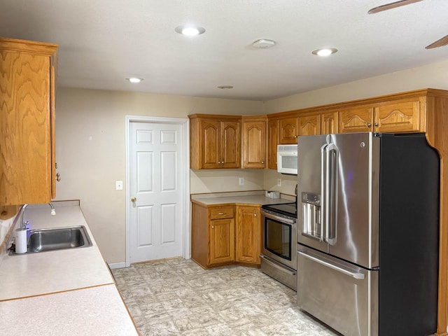 221 Beachwood St, Theodosia, MO 65761 - kitchen with a sink, brown cabinetry, ceiling fan, light countertops, and appliances with stainless steel finishes