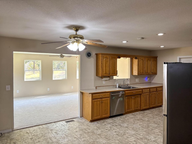 221 Beachwood St, Theodosia, MO 65761 - kitchen featuring light floors, light countertops, a sink, brown cabinetry, and appliances with stainless steel finishes
